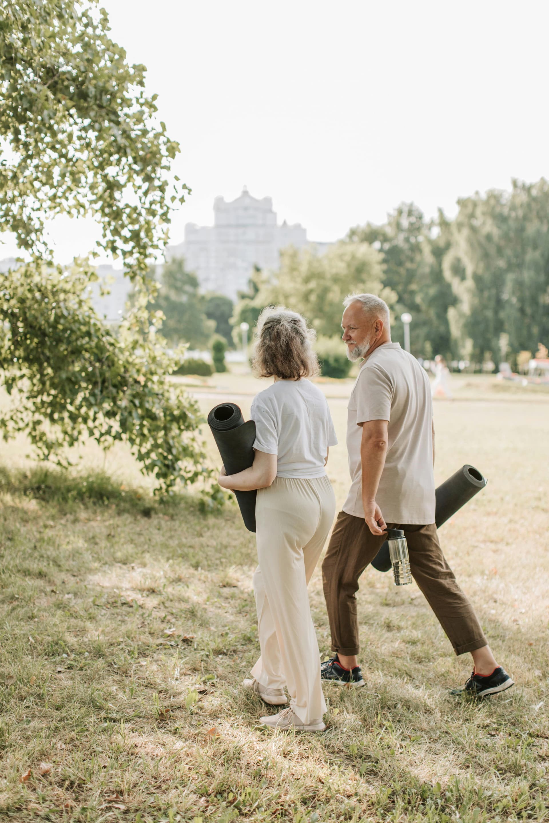 Senior couple doing yoga in the park.